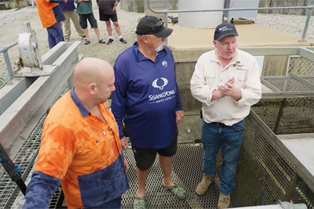 Dr Ivor Stuart and Merv Hughes at the Torrumbarry fishway on the River Murray with Goulburn Murray Water staff. Dr Stuart is explaining how fish are trapped and tagged, and the significant distances they travel along the river.