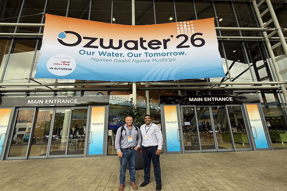 Ozwater 2026 two men infront of the conference banner